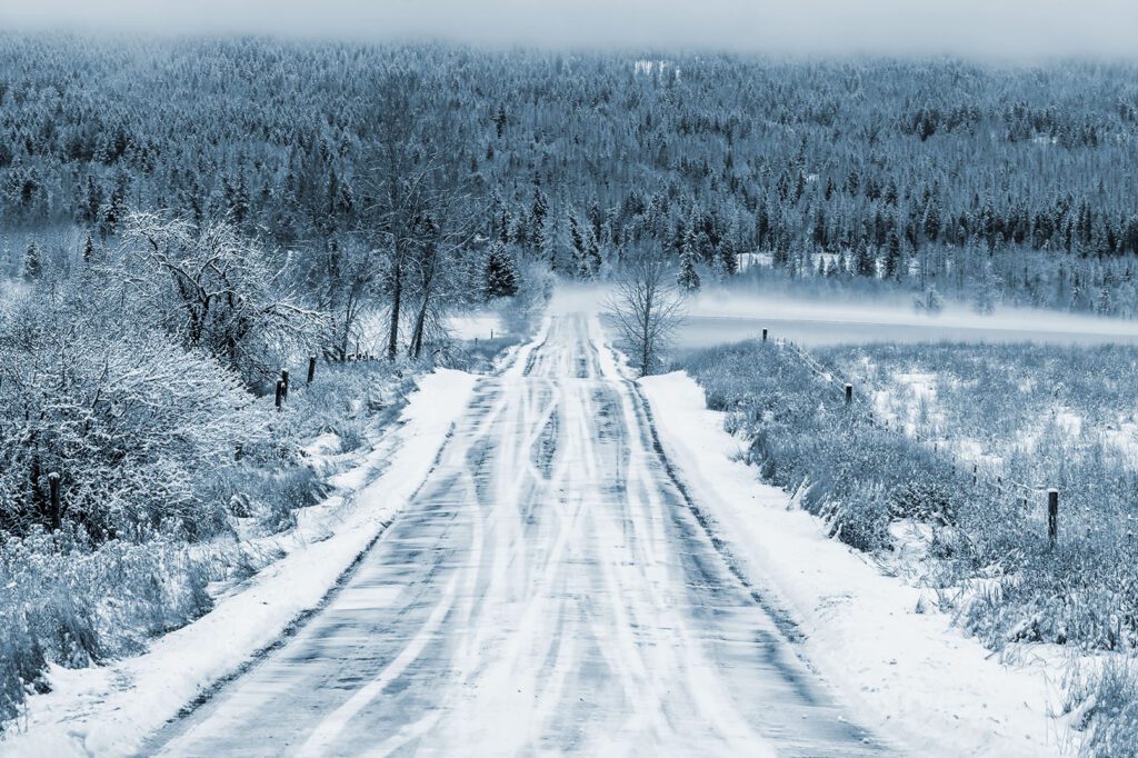 Early morning fresh snow fall on rural road in northwest Montana
