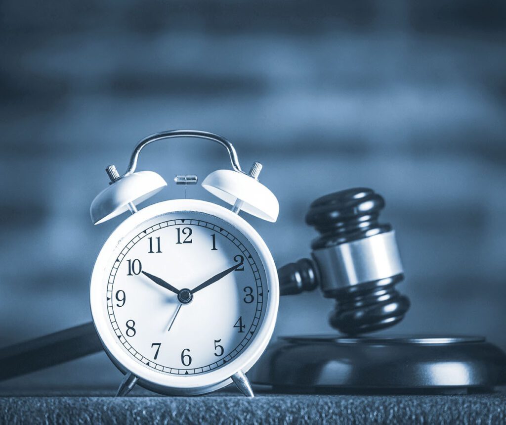 Gavel and clock on blue background