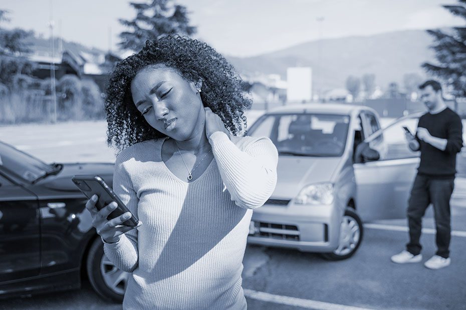 Black woman calling roadside service insurance support after car crash