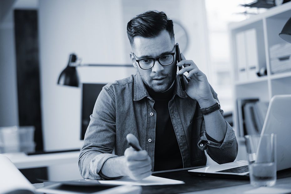 man talking on phone at work.