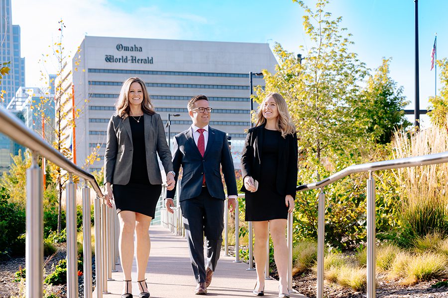 Attorneys walking forward on a bridge.