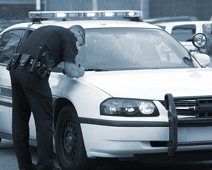 Police officer writes a ticket on his vehicle