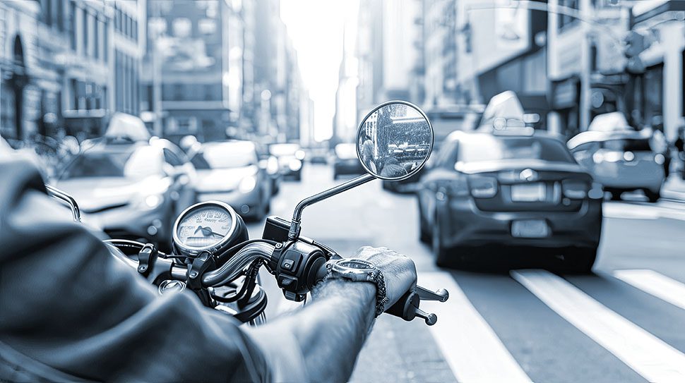 With style and speed, the motorcyclist navigates urban traffic, leaving a trail of excitement in their wake.